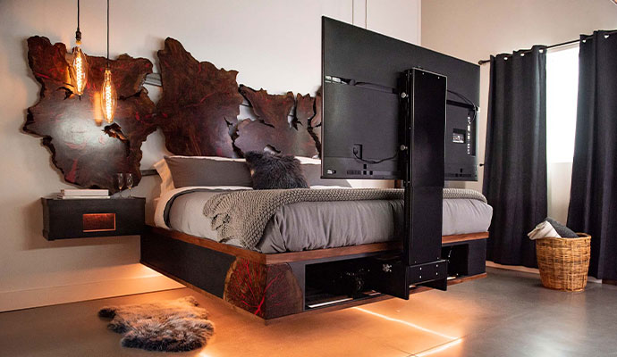 A modern bedroom suite featuring a motorized TV lift system
