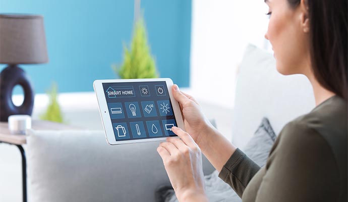 A person using a home automation app on a tablet