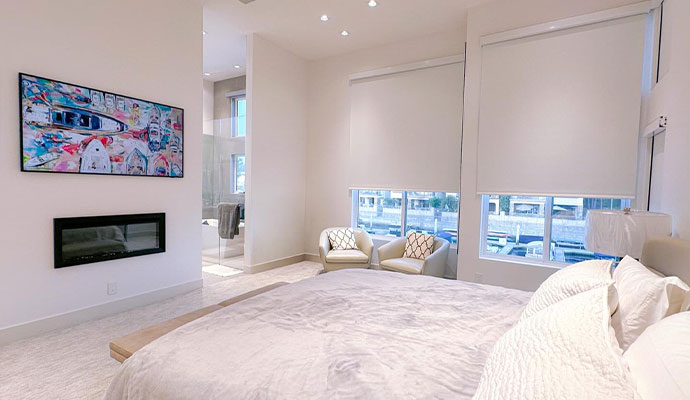 A wide, bright view of a luxury modern bedroom