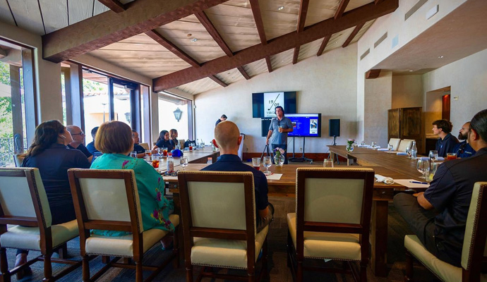 Business presentation in beamed meeting room with audience