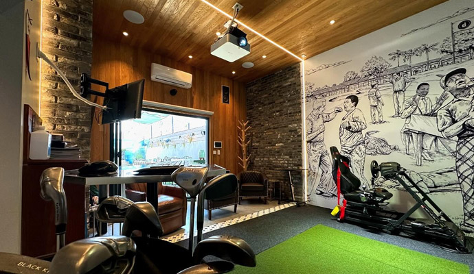 Indoor recreation lounge with golf clubs and racing simulator