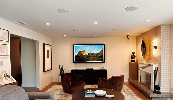 Modern living room with wall mounted tv and in ceiling speakers
