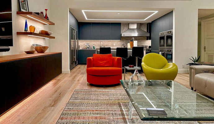 Modern lounge with led shelving and colorful accent chairs