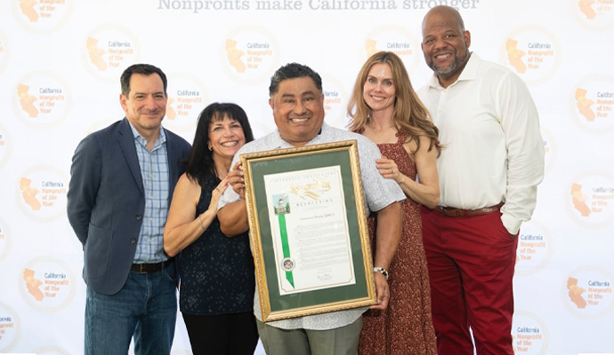 Team holding California nonprofit of the year award