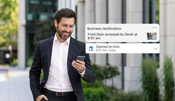 Businessman viewing access control notifications on smartphone
