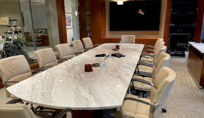 Conference room with marble table and wall mounted screen