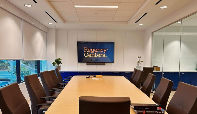 Conference room with wooden table and wall mounted tv