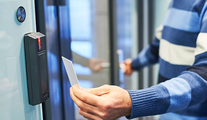 Person using access card at electronic door reader