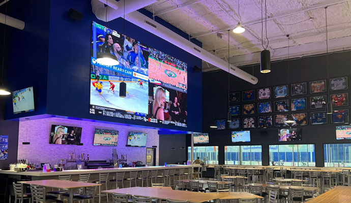 Sports bar with large video wall and ice rink view
