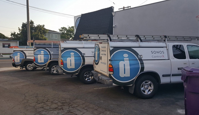 Digital Installers pickup trucks parked in a row.
