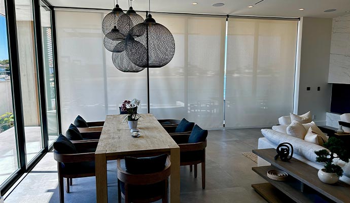 Dining table and living room with pendant lights