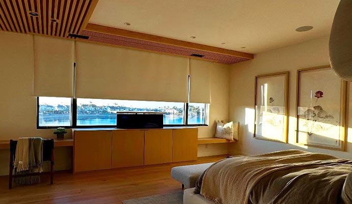 Modern bedroom with motorized window coverings Modern bedroom featuring motorized window coverings for convenience and light control