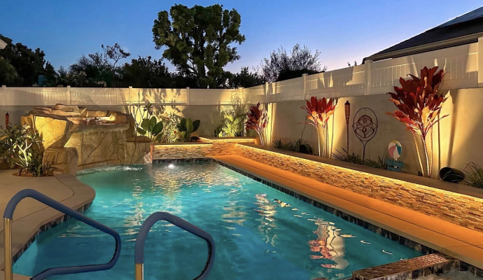 Residential pool area with landscape lighting
