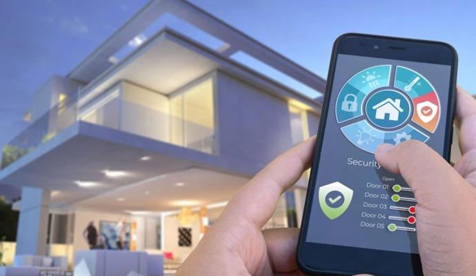 Smart home automation control via mobile app Person using a smartphone app to control smart home automation features in front of a modern house