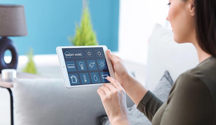 Woman controlling smart home on tablet