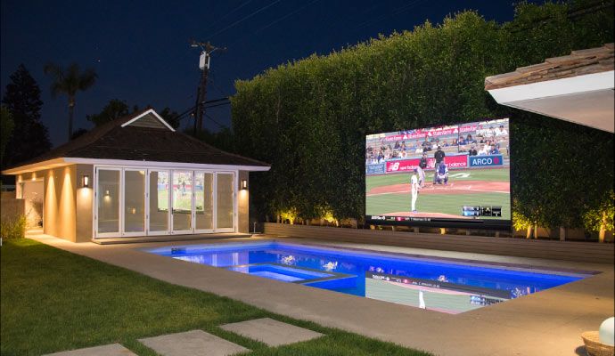 Installed outdoor weatherproof television near the pool for entertainment