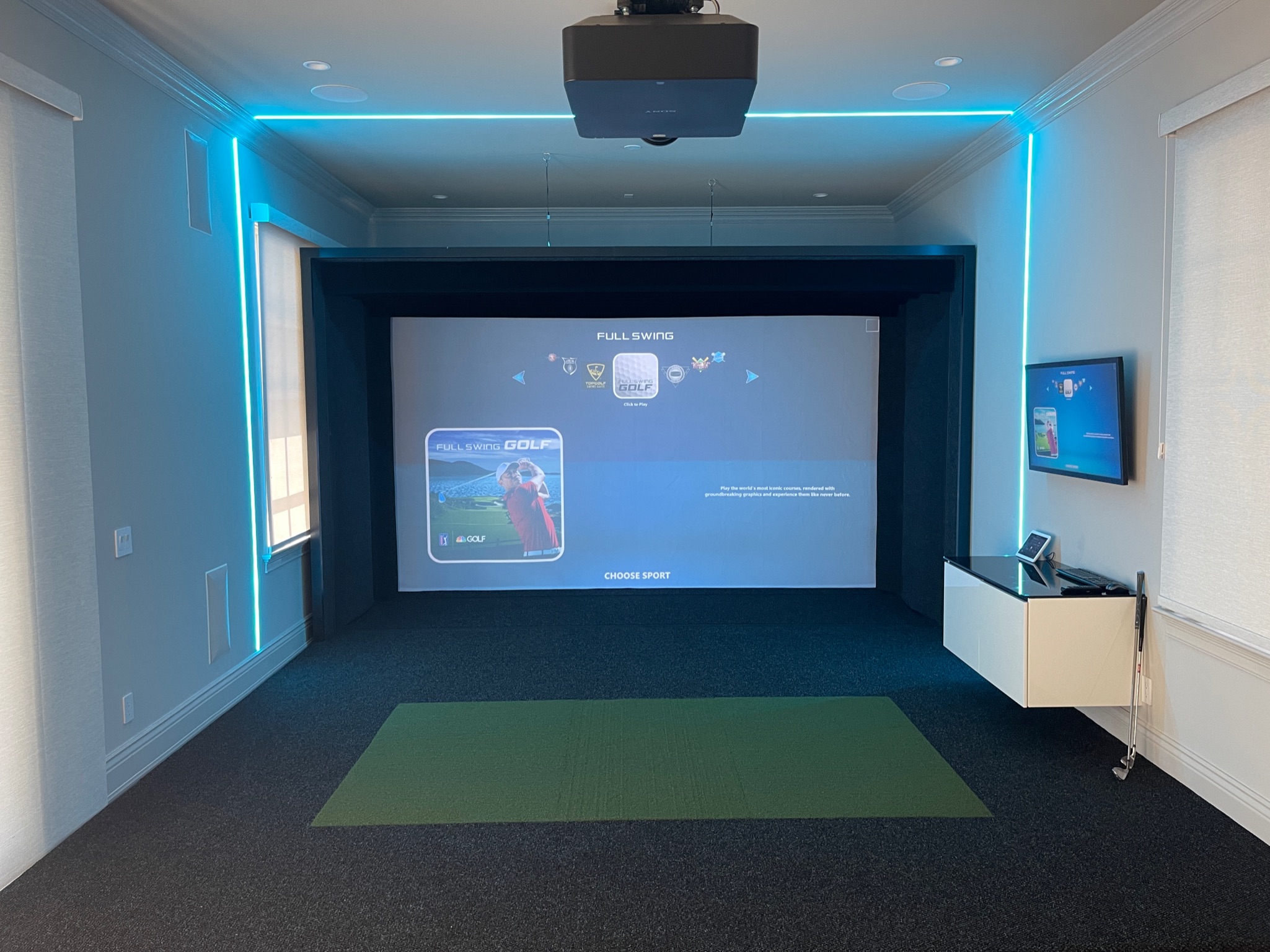 This was a fun room we designed adding linear lighting, oversized touch screen and a floating cabinet all controlled by Control4.
