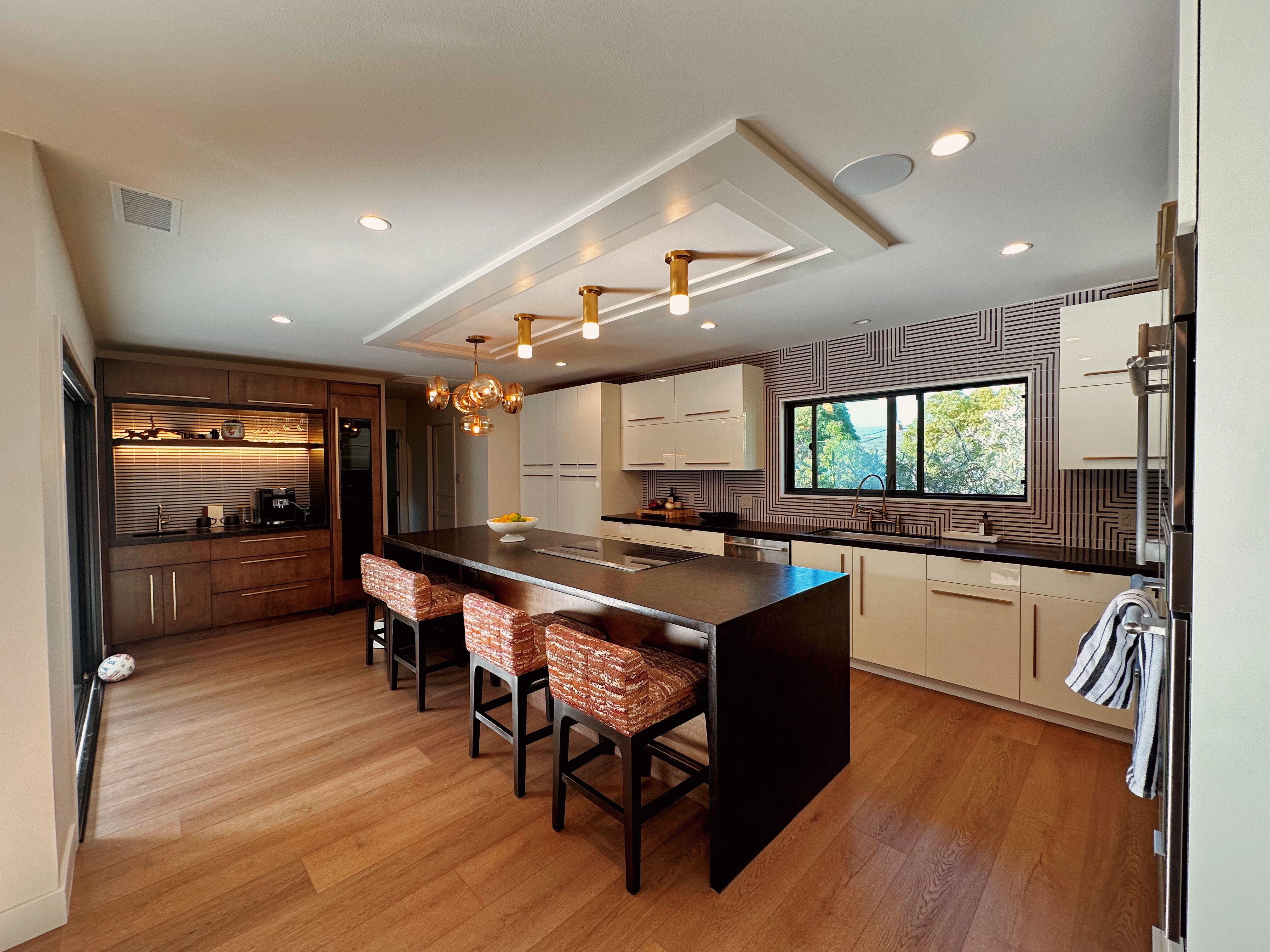 In the kitchen, we installed Lutron RA3 lighting control with custom keypad colors to match the room’s design, creating a cohesive and polished look. We also added in-ceiling speakers to bring high-quality sound into the space without interrupting the clean aesthetic.