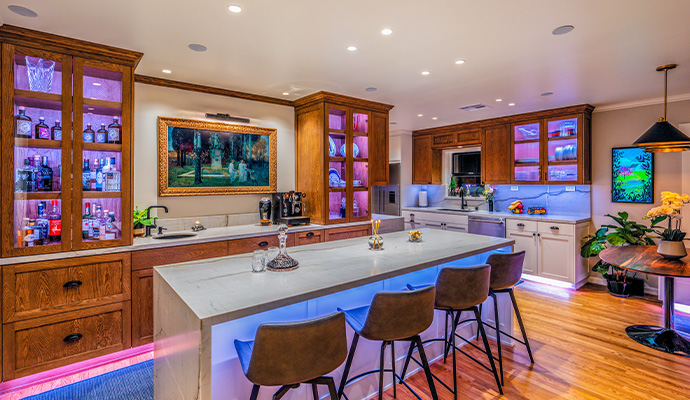 Kitchen island and cabinetry with linear LED lighting