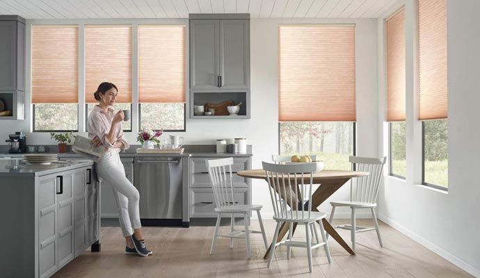 Motorized window covering installed in a modern kitchen