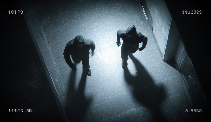 Night vision security camera footage of intruders