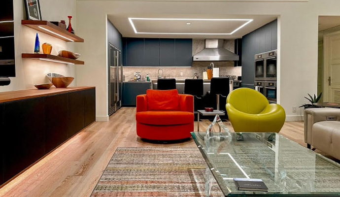 Open-concept living room and kitchen with modern furniture.