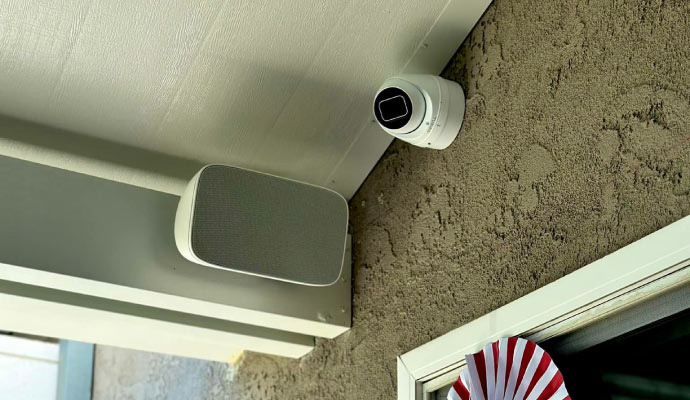 Outdoor dome security camera mounted on a patio wall.