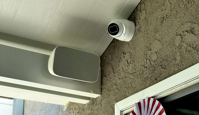 Outdoor security camera and speaker mounted under soffit