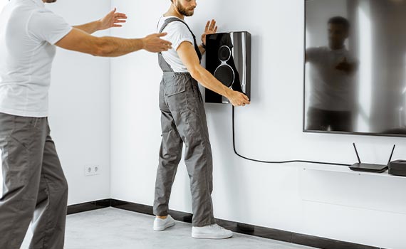 Professional worker installing surround sound