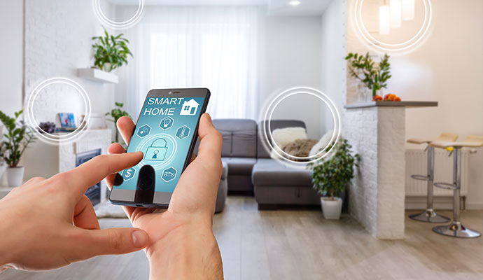 Person  hands hold a smartphone displaying a smart home control app
