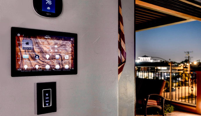 Wall-mounted smart thermostat and home lighting control panel.
