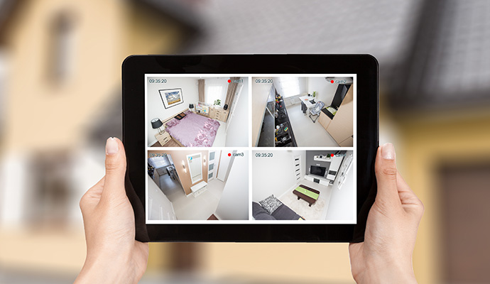 Tablet displaying live home security camera feeds