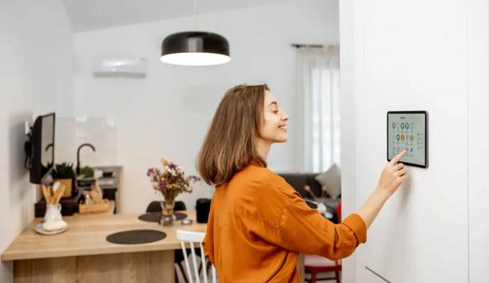 Woman using smart home control panel