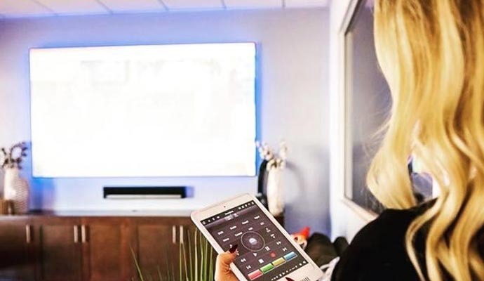 Woman using tablet for smart home media and lighting control
